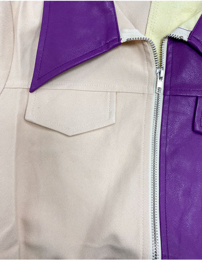 Woman wearing a Color-Block Leather and Fabric Jacket with a purple leather front and beige fabric sleeves and back, featuring a zip-up front and snap-button details.