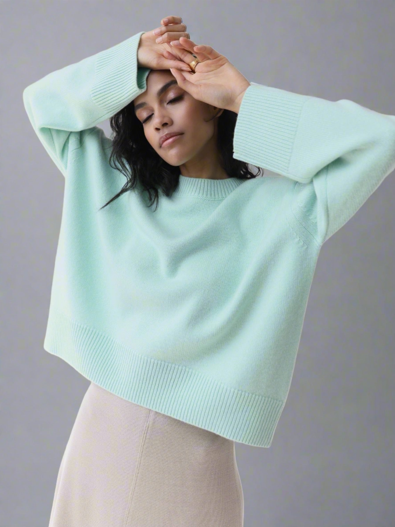 Woman wearing an oversized cashmere sweater.