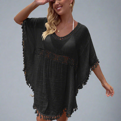 Woman wearing a boho crochet tassel cover-up in black