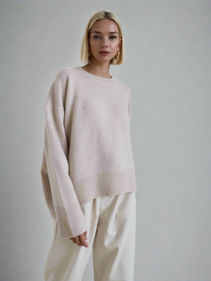 Woman wearing a beige oversized cashmere sweater.