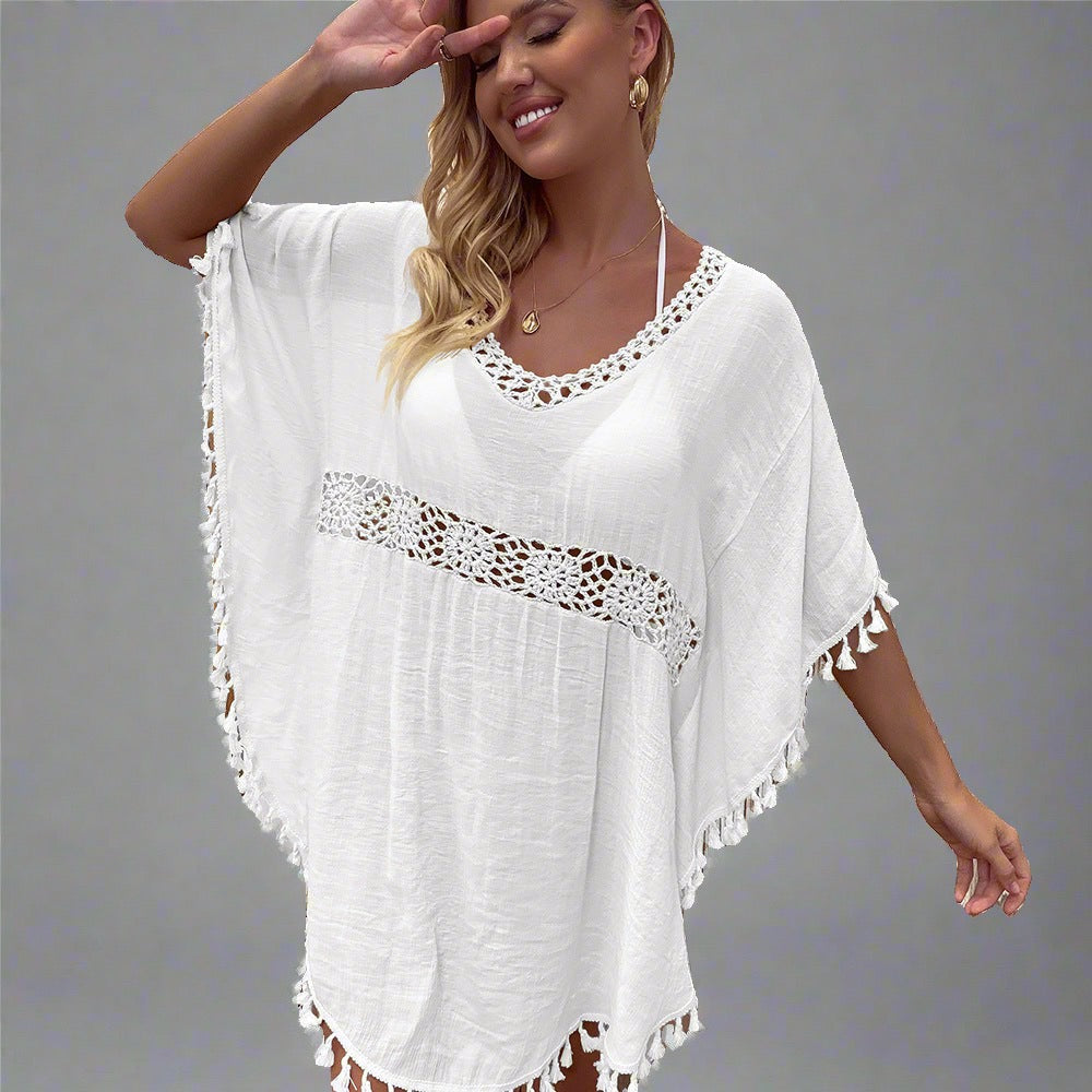 Woman wearing a boho crochet tassel cover-up in white