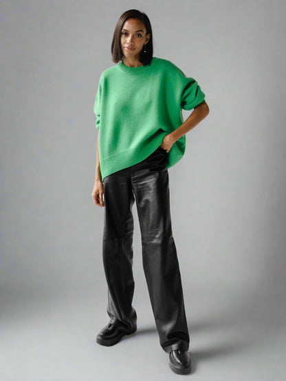 Woman wearing a green oversized cashmere sweater.