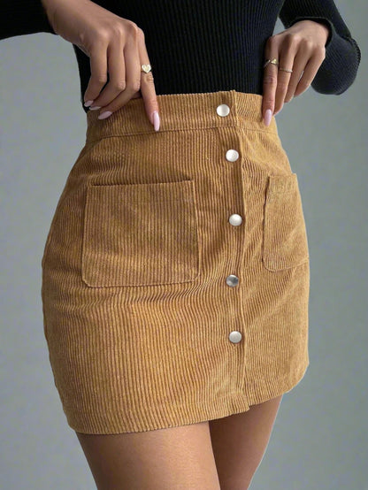 Woman wearing a High-Waist Corduroy Button-Up Skirt in a warm, earthy tone, featuring a front button-up closure and two front pockets.