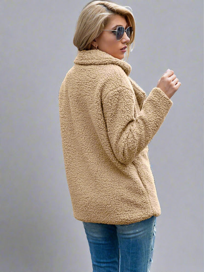 Woman wearing a Cozy Sherpa Fleece Jacket in cream, featuring a double-breasted front with large buttons, paired with jeans and a white top.