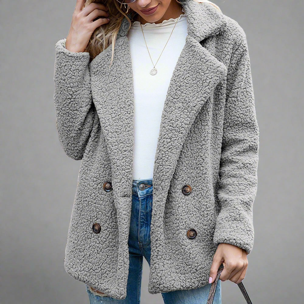 Woman wearing a Cozy Sherpa Fleece Jacket in cream, featuring a double-breasted front with large buttons, paired with jeans and a white top.