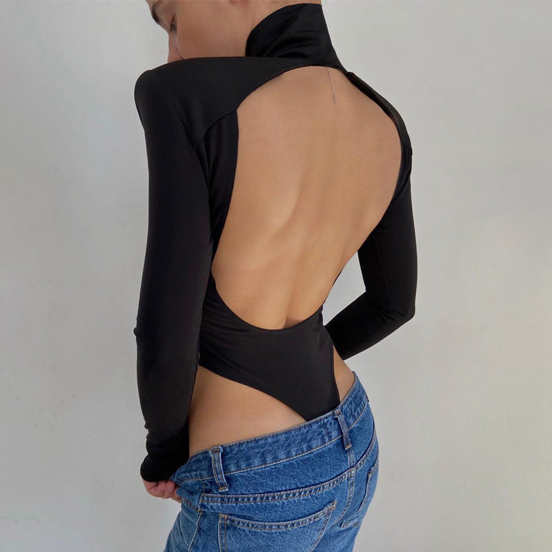 Model wearing the Bold Allure Open-Back Long Sleeve Bodysuit in black, ideal for stylish travel outfits