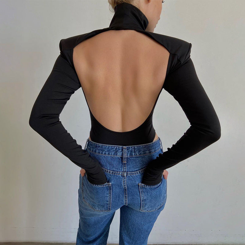 Model wearing the Bold Allure Open-Back Long Sleeve Bodysuit in black, ideal for stylish travel outfits