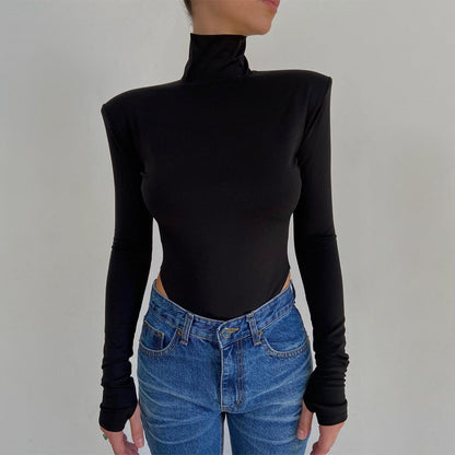 Model wearing the Bold Allure Open-Back Long Sleeve Bodysuit in black, ideal for stylish travel outfits