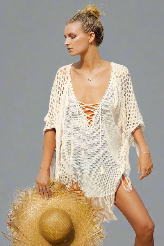 Woman wearing a white fringe beach cover-up.