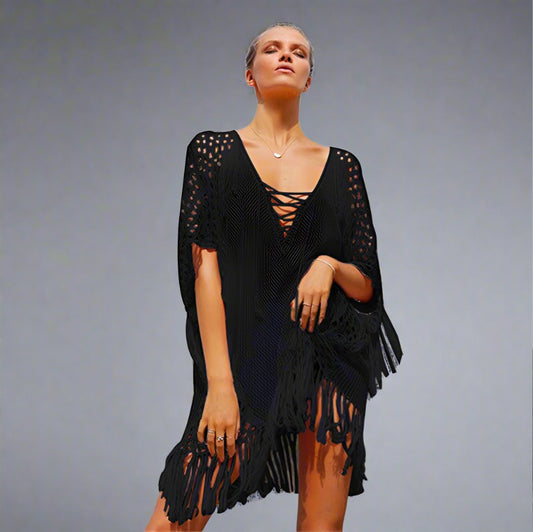 Woman wearing a black fringe beach cover-up.