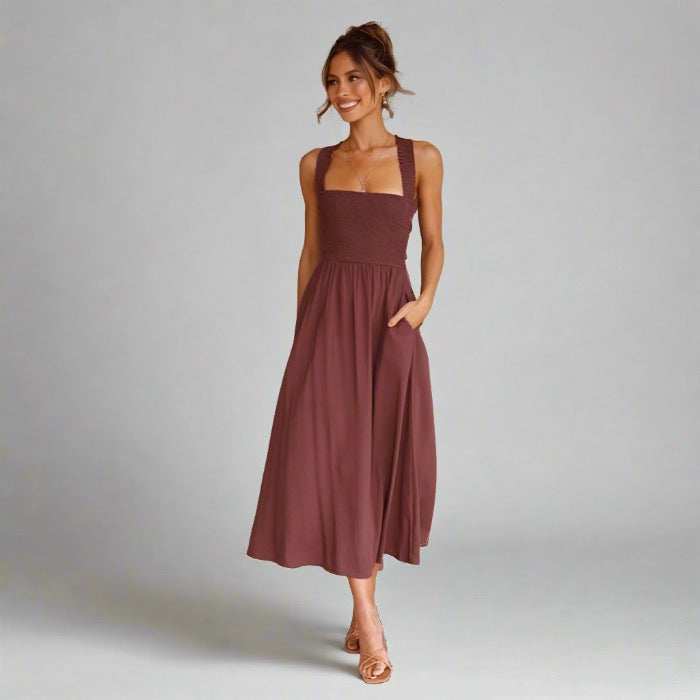 Woman wearing an elegant back-tie midi dress in brown.