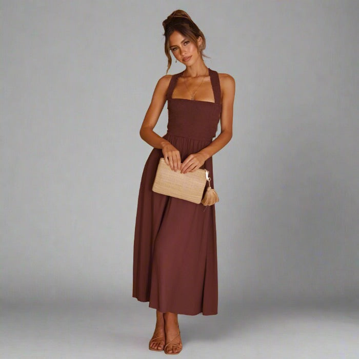 Woman wearing an elegant back-tie midi dress in brown.