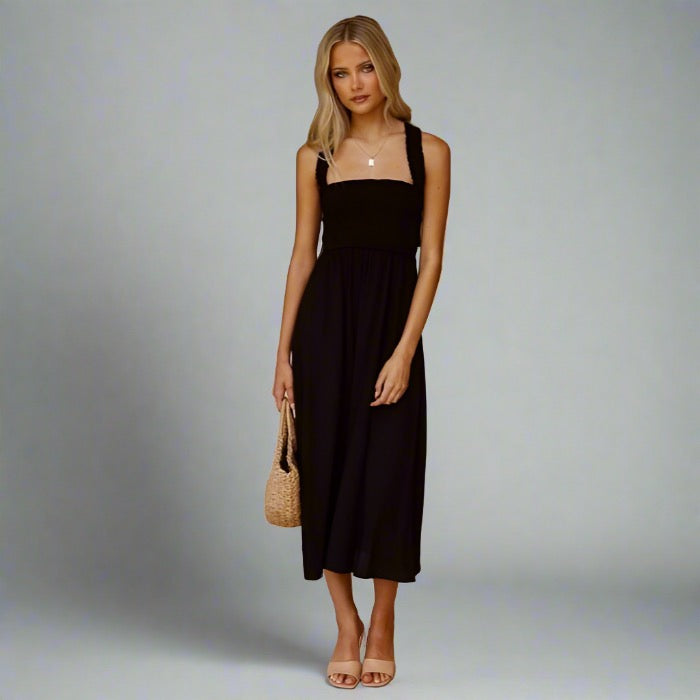 Woman wearing an elegant back-tie midi dress in black