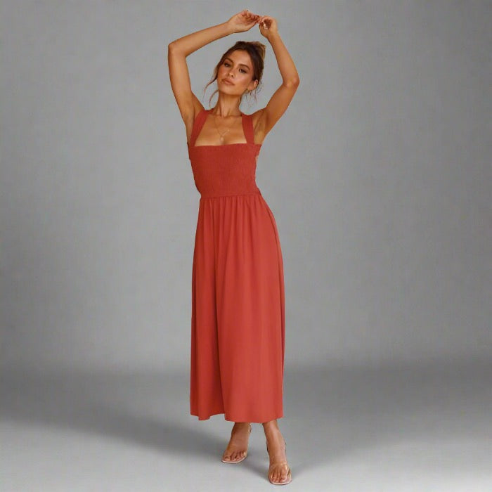 Woman wearing an elegant back-tie midi dress in orange