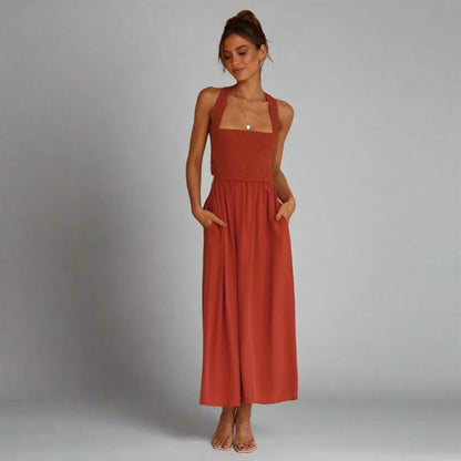 Woman wearing an elegant back-tie midi dress in orange