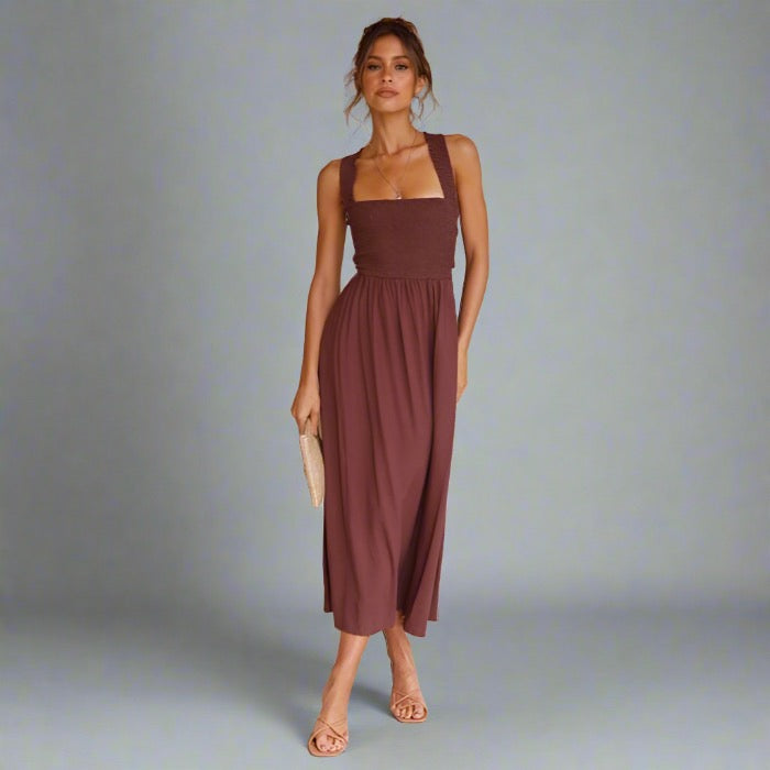 Woman wearing an elegant back-tie midi dress in brown.