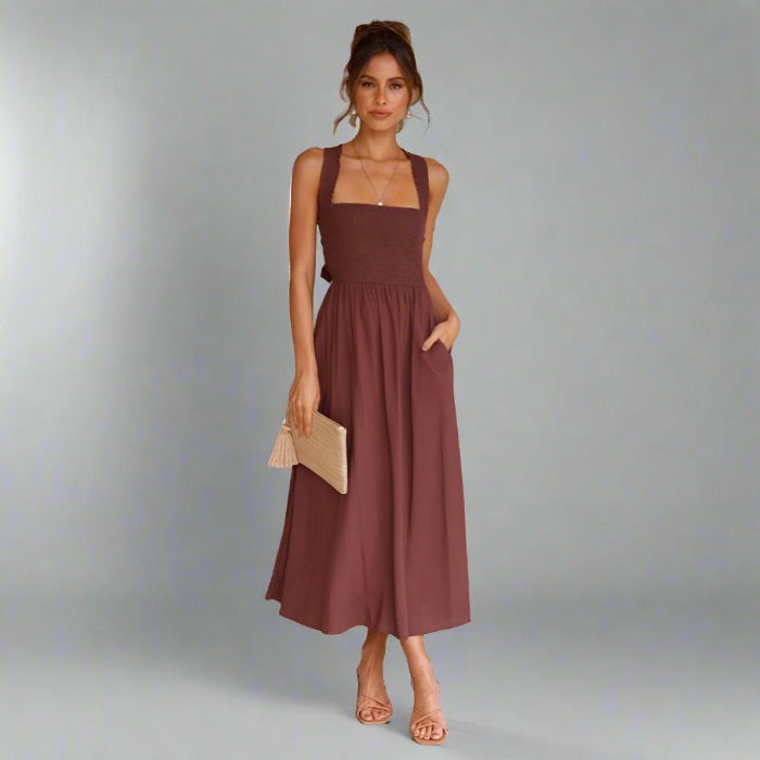 Woman wearing an elegant back-tie midi dress in brown.