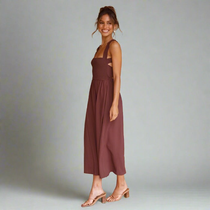 Woman wearing an elegant back-tie midi dress in brown.