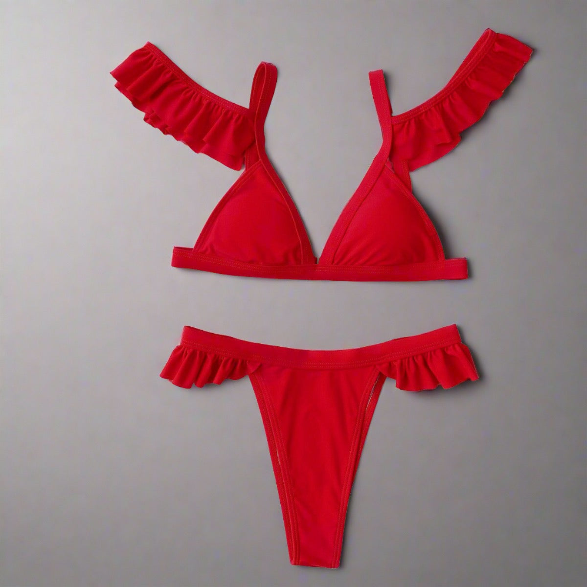 Flirty Ruffle-Trim Red Bikini with adjustable straps, secure back clasp, and ruffle details on shoulders and waist.