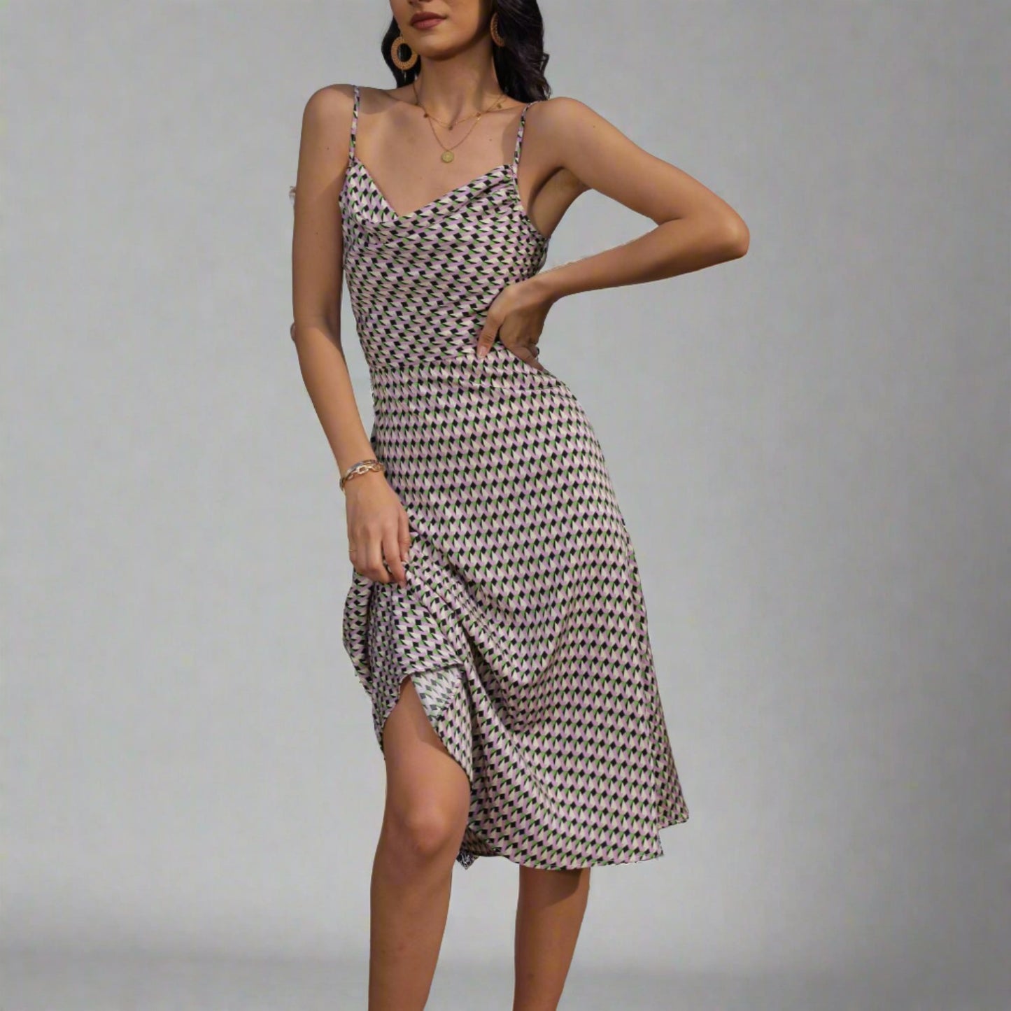 Woman wearing a Geometric Pattern Midi Dress with adjustable spaghetti straps.