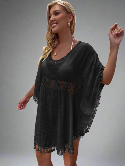 Woman wearing a boho crochet tassel cover-up in black