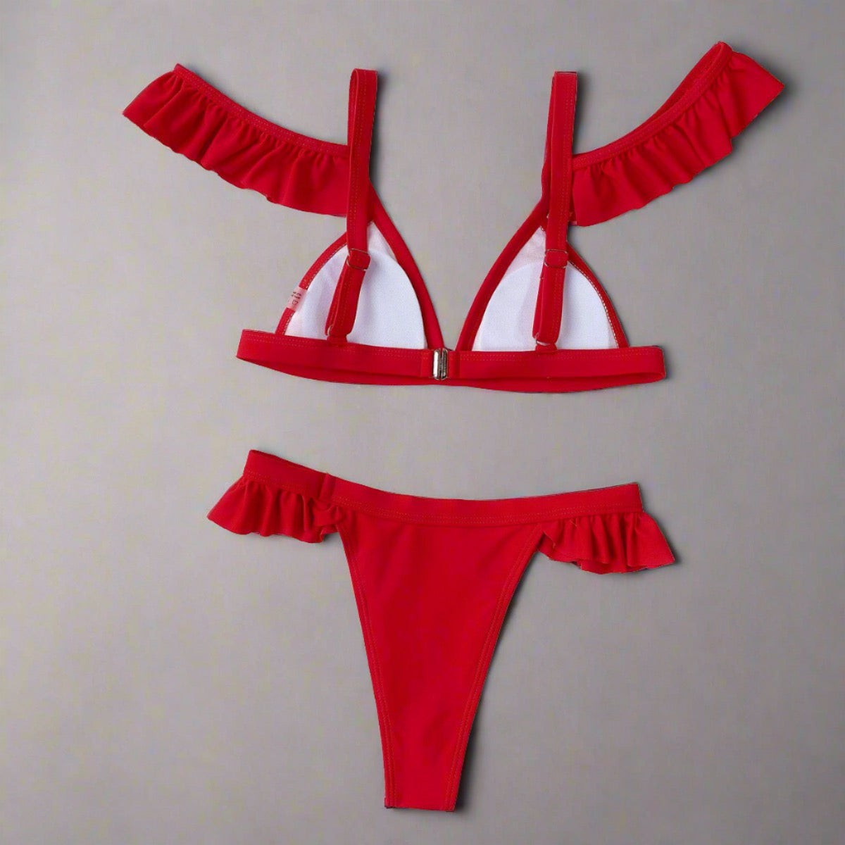 Flirty Ruffle-Trim Red Bikini with adjustable straps, secure back clasp, and ruffle details on shoulders and waist.