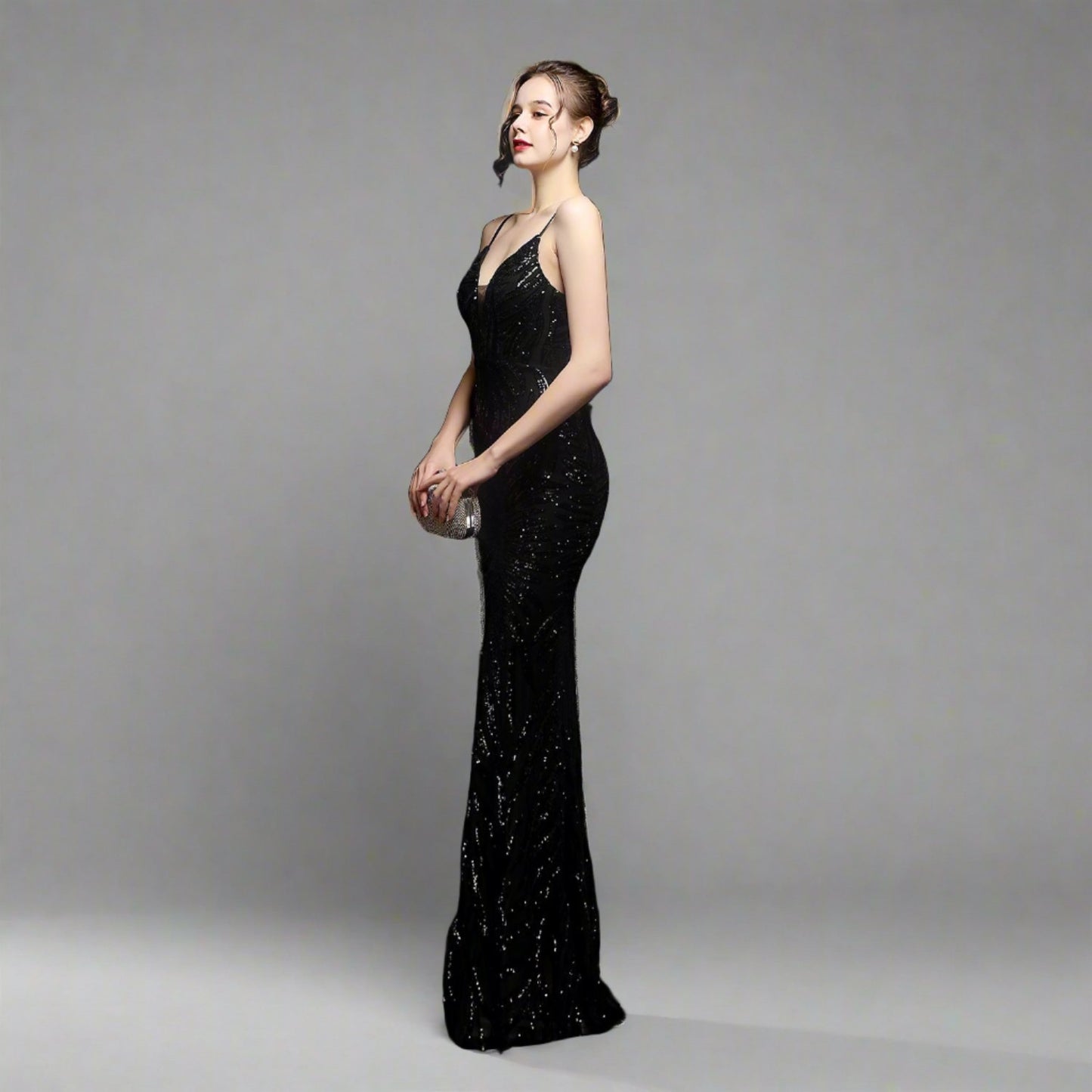 Model wearing Luxury Traveler's Sequin Gala Gown in black, featuring a body-hugging silhouette with intricate sequin details and spaghetti straps