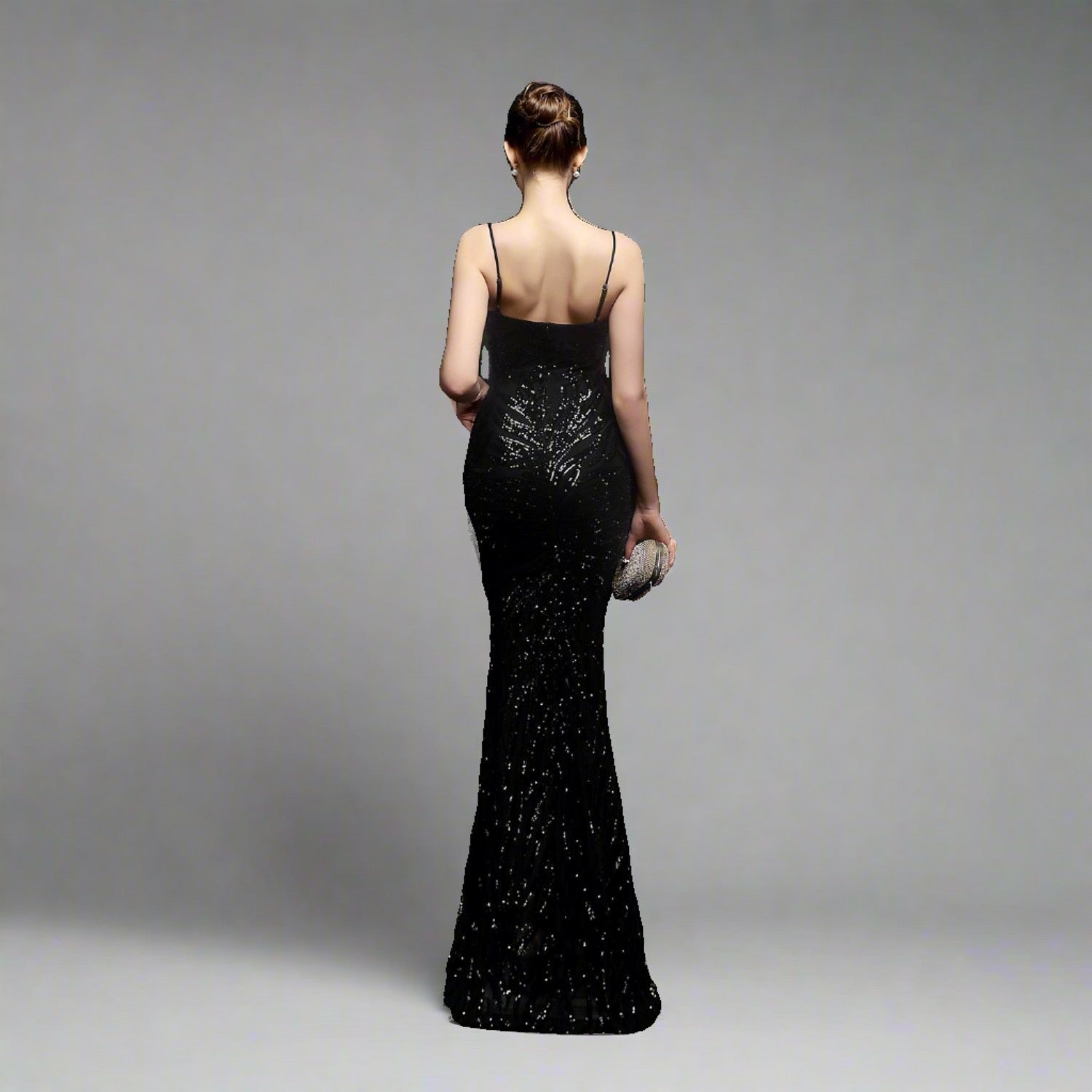 Model wearing Luxury Traveler's Sequin Gala Gown in black, featuring a body-hugging silhouette with intricate sequin details and spaghetti straps