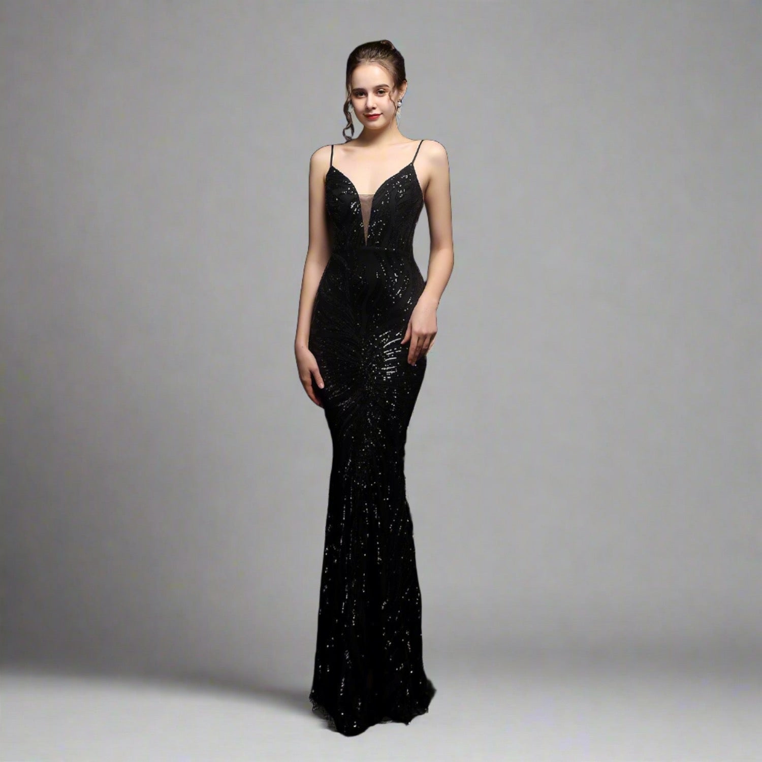 Model wearing Luxury Traveler's Sequin Gala Gown in black, featuring a body-hugging silhouette with intricate sequin details and spaghetti straps