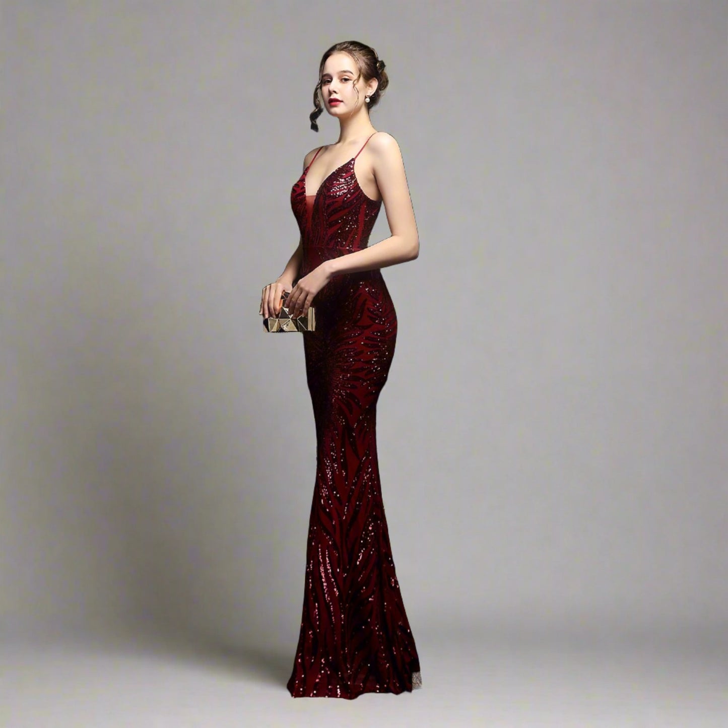 Model wearing Luxury Traveler's Sequin Gala Gown in maroon, featuring a body-hugging silhouette with intricate sequin details and spaghetti straps