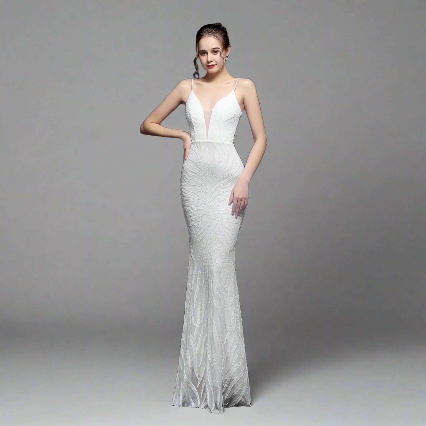 Model wearing Luxury Traveler's Sequin Gala Gown in white, featuring a body-hugging silhouette with intricate sequin details and spaghetti straps