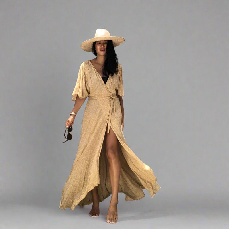 Woman wearing a Golden Sands Wrap Dress, perfect for travel and beach vacations.